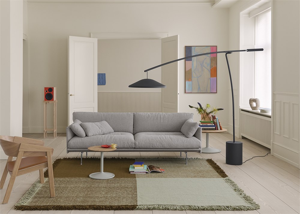 Muuto Contra counterweighted floor lamp reaching over a gray sofa