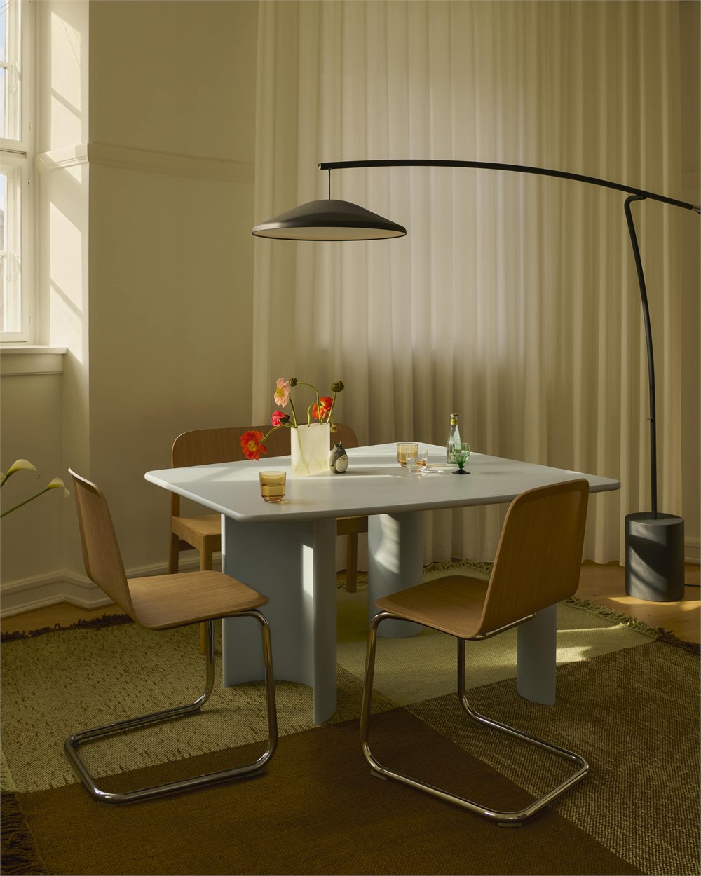 Contra floor lamp illuminating a dining table