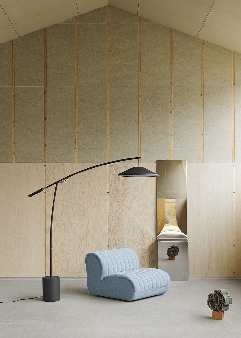 Full Contra lamp beside a low blue lounge chair