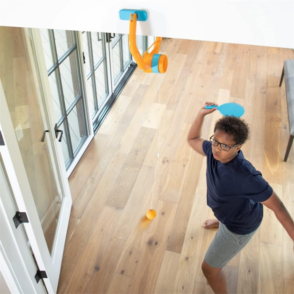 Door Pong setup with tethered orange ball hanging from the clamp