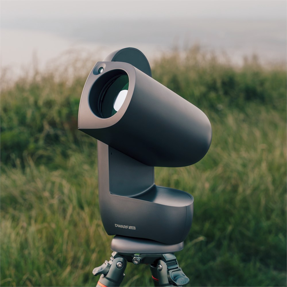 Draco telephoto lens facing outward above a grassy field