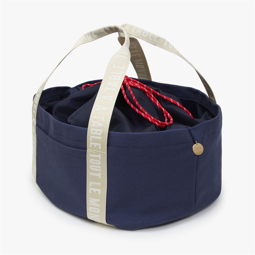 Angled view of navy canvas tote and drawstring closure