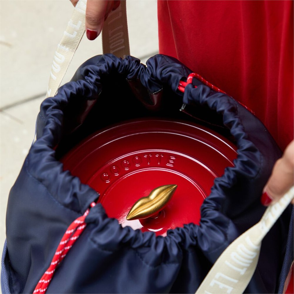 Red Dutch oven inside the insulated carrier