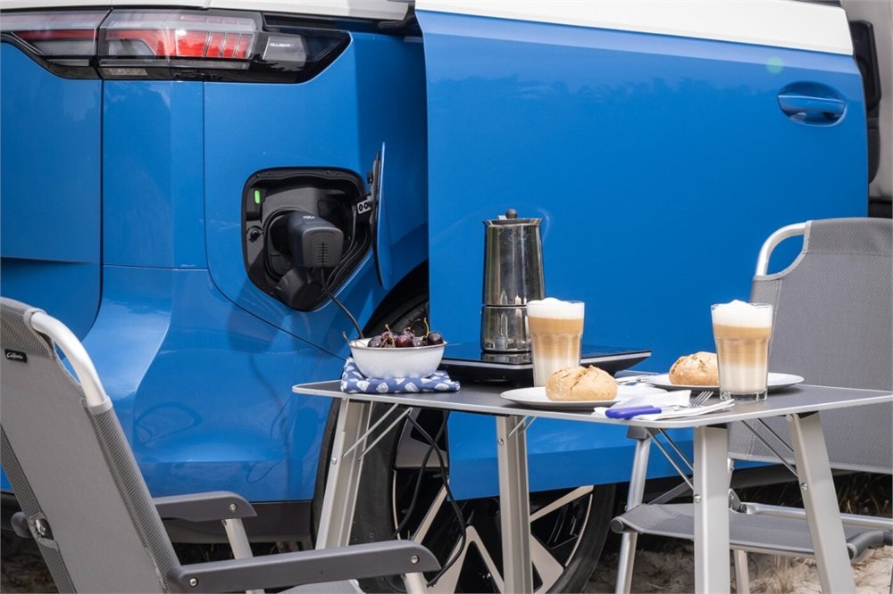 Vehicle-to-load adapter supplying an outdoor breakfast setup
