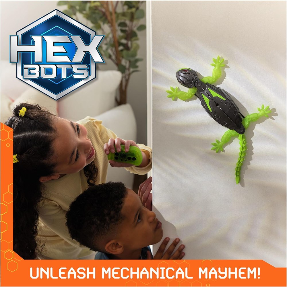 Two children watching the remote-control gecko on a wall