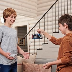 Two children practicing with the hand-controlled Gravitor indoors