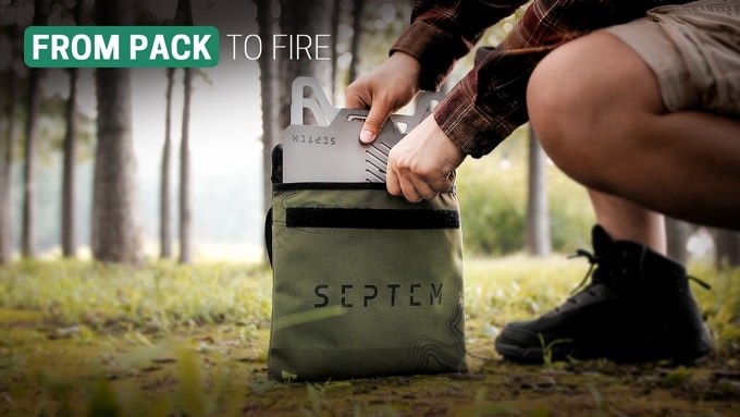 Camper unpacking the flat titanium grill from a carrying bag