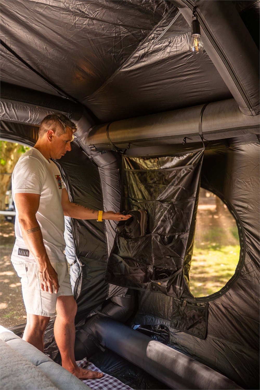 Camper standing inside the inflatable family tent