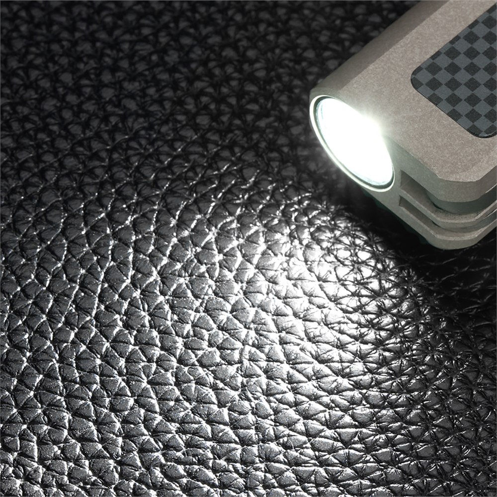Main flashlight beam on a textured dark surface