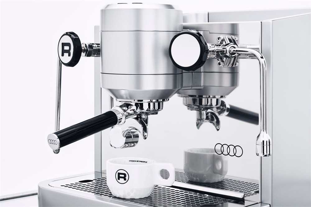 Front brewing unit and espresso cup on the drip tray