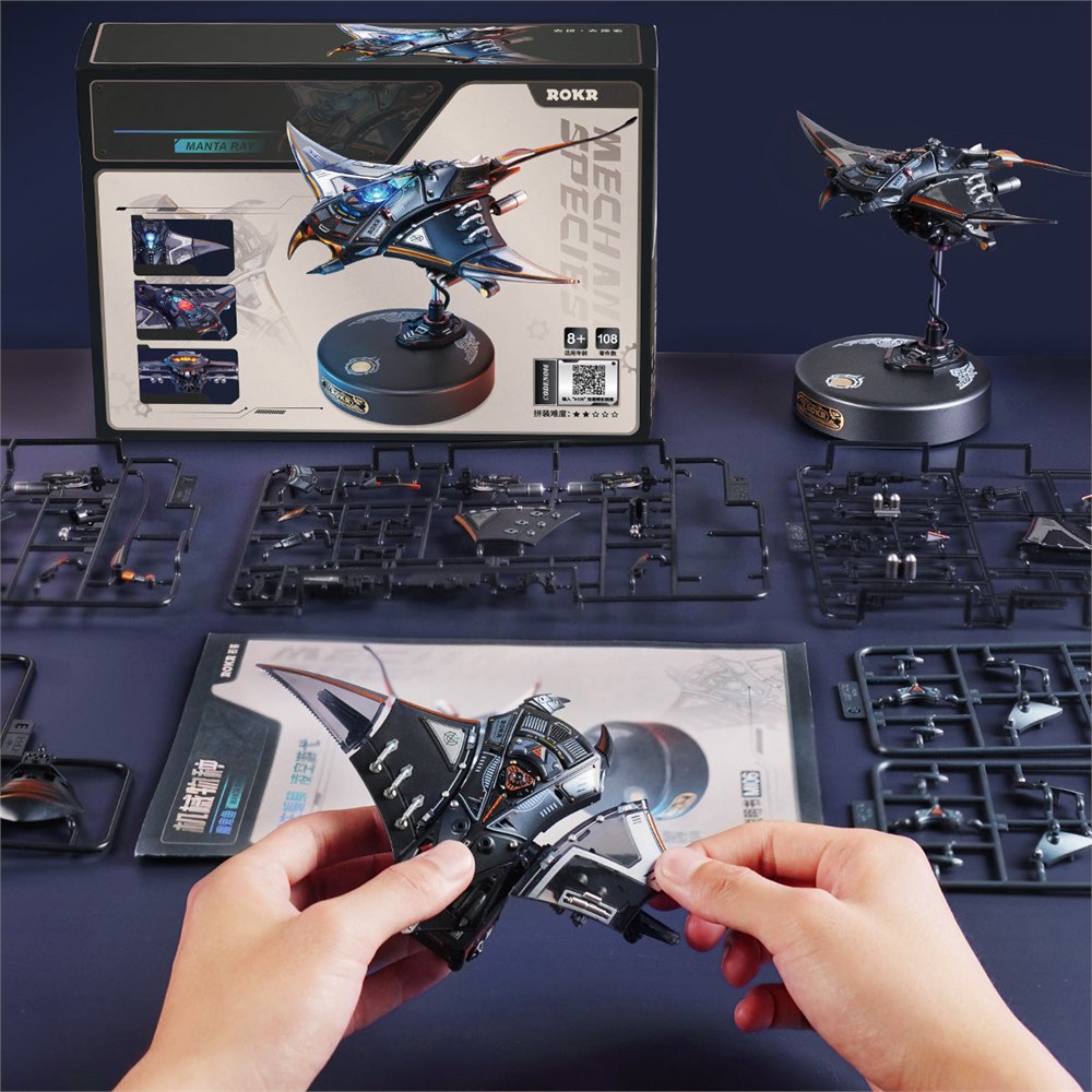 Manta ray kit with parts, instructions, and a model being assembled