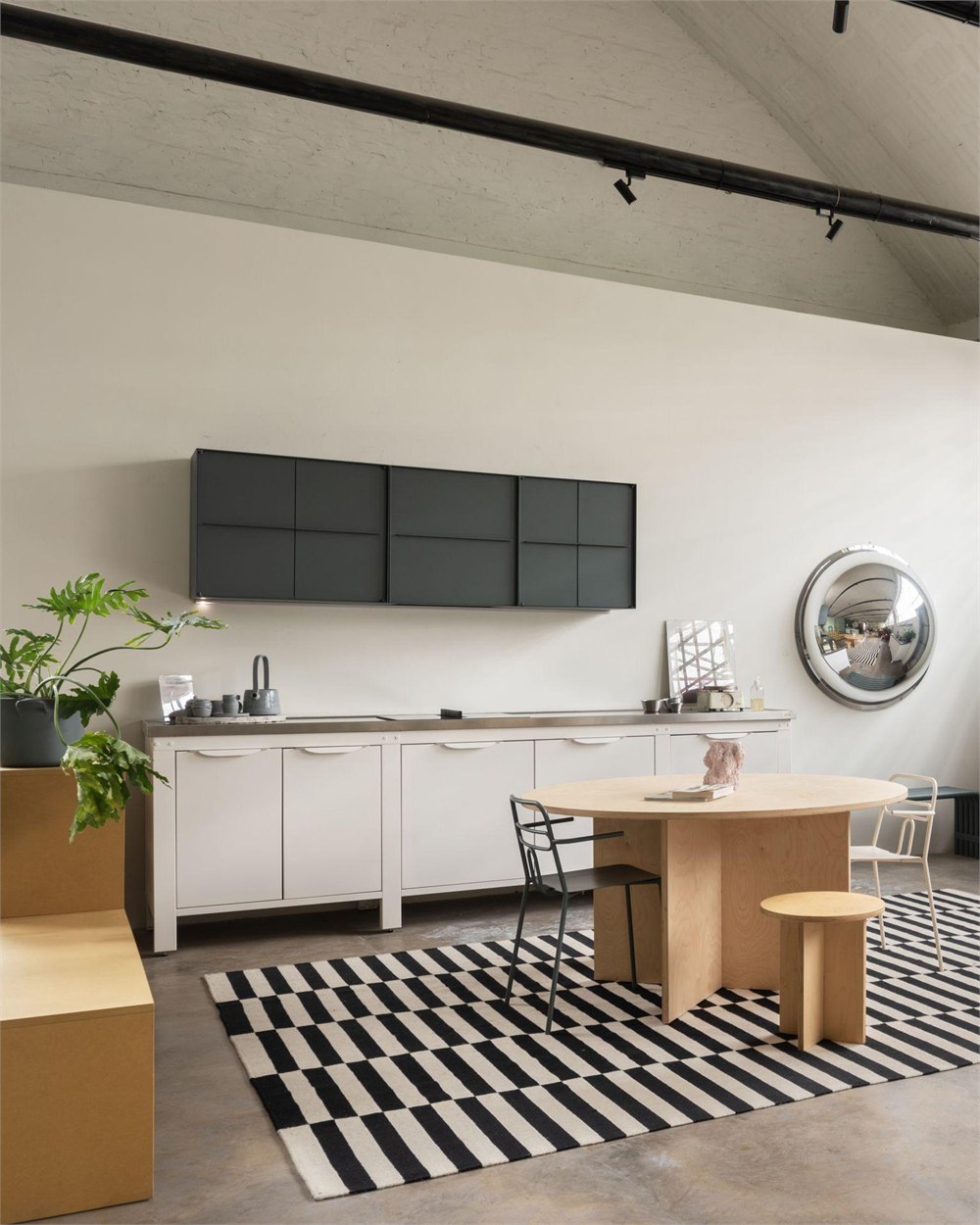 Light-colored modular kitchen beneath dark wall cabinets
