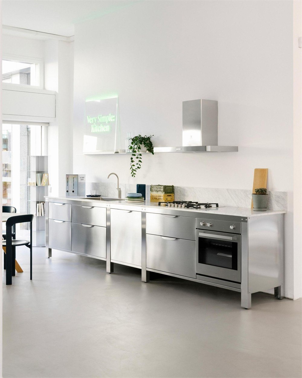 Freestanding stainless steel kitchen modules with sink, cooktop, oven and exposed legs