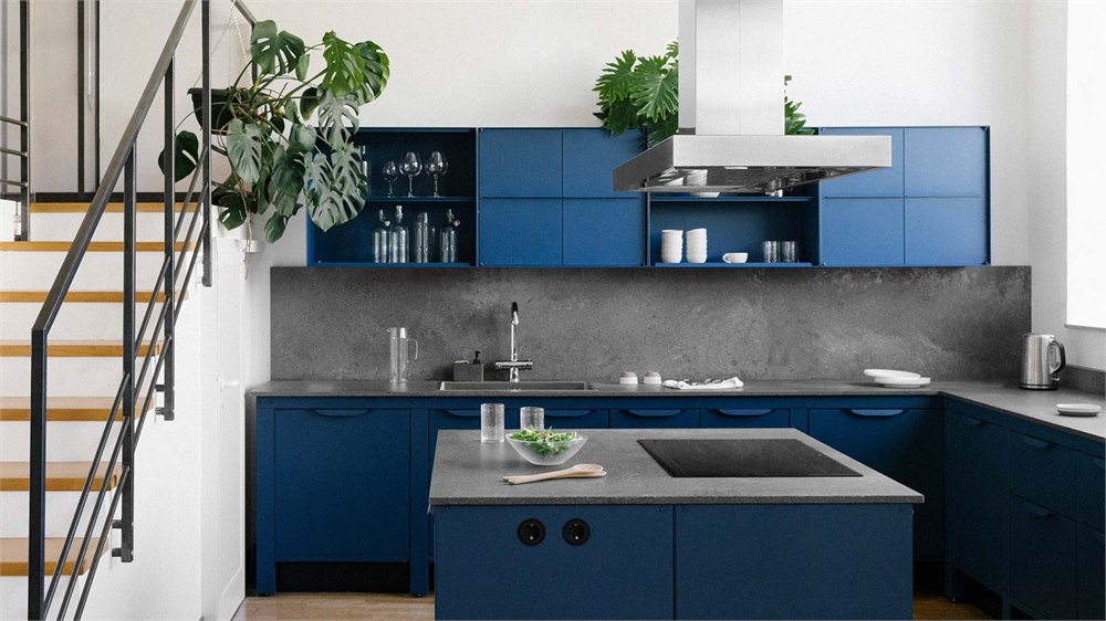 Blue modular kitchen with an island and matching wall cabinets