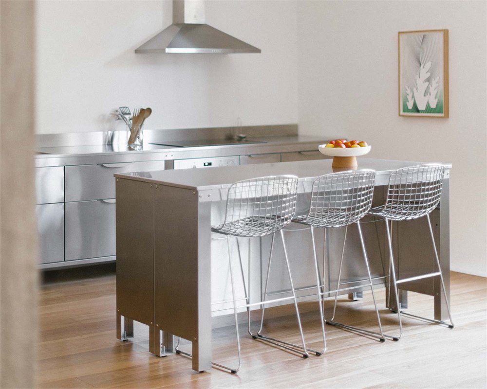 Stainless steel kitchen with a separate island and bar seating