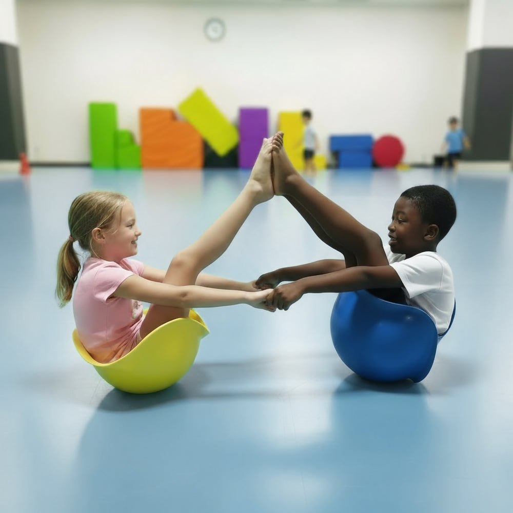 Children balancing in yellow and blue MOLUK Bilibo shells during active play.