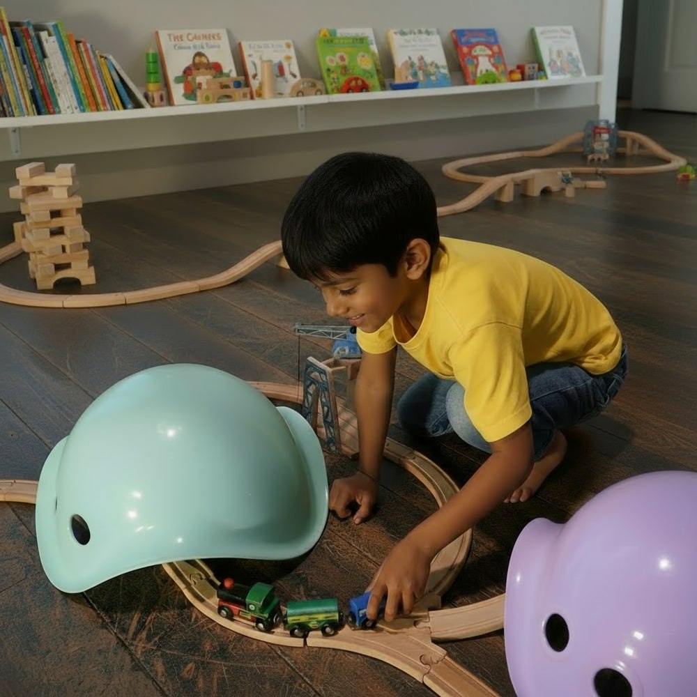 Mint and lilac MOLUK Bilibo shells used as toy train tunnels.