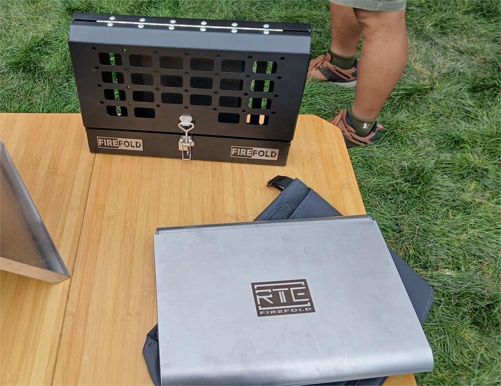 FireFold kit with propane tank and vehicle case on a camp table