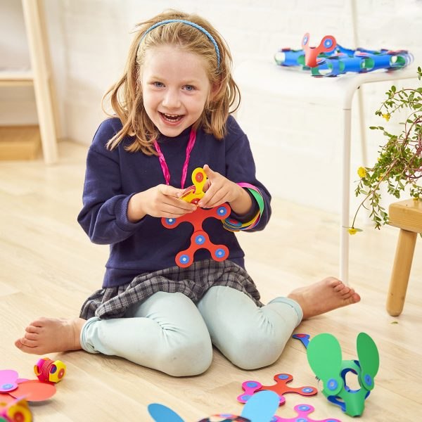 Child playing with colorful Clixo Rainbow Pack flexible magnetic pieces
