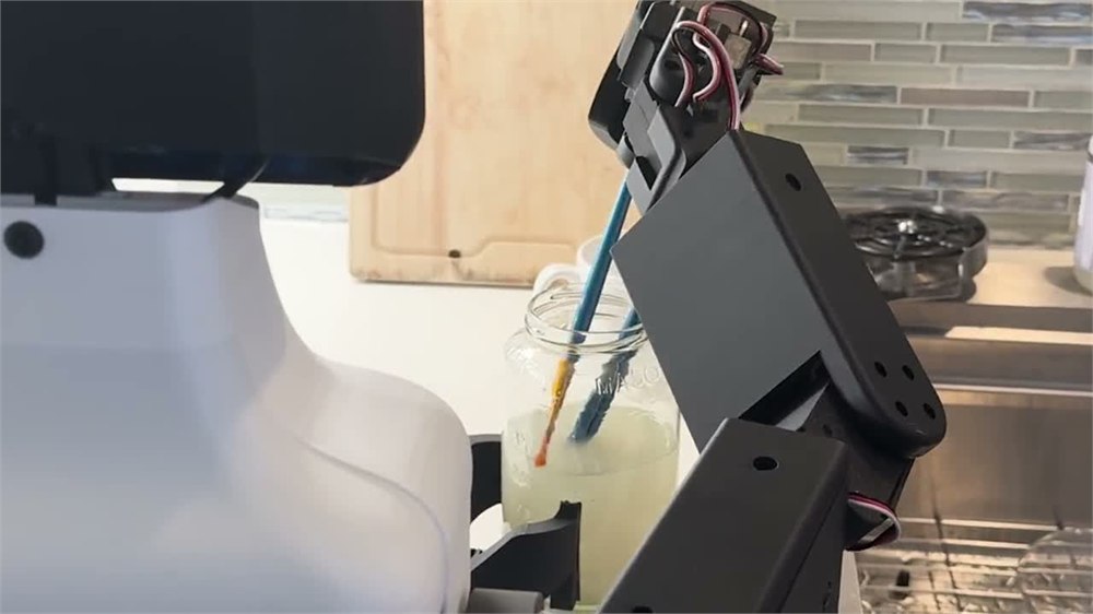 NORI robot handling a paintbrush over a jar in an official demonstration