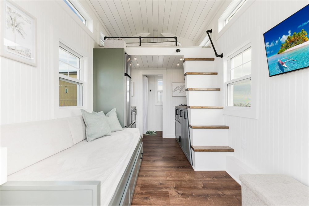 Living room inside the Petite Pelican tiny house with daybed seating