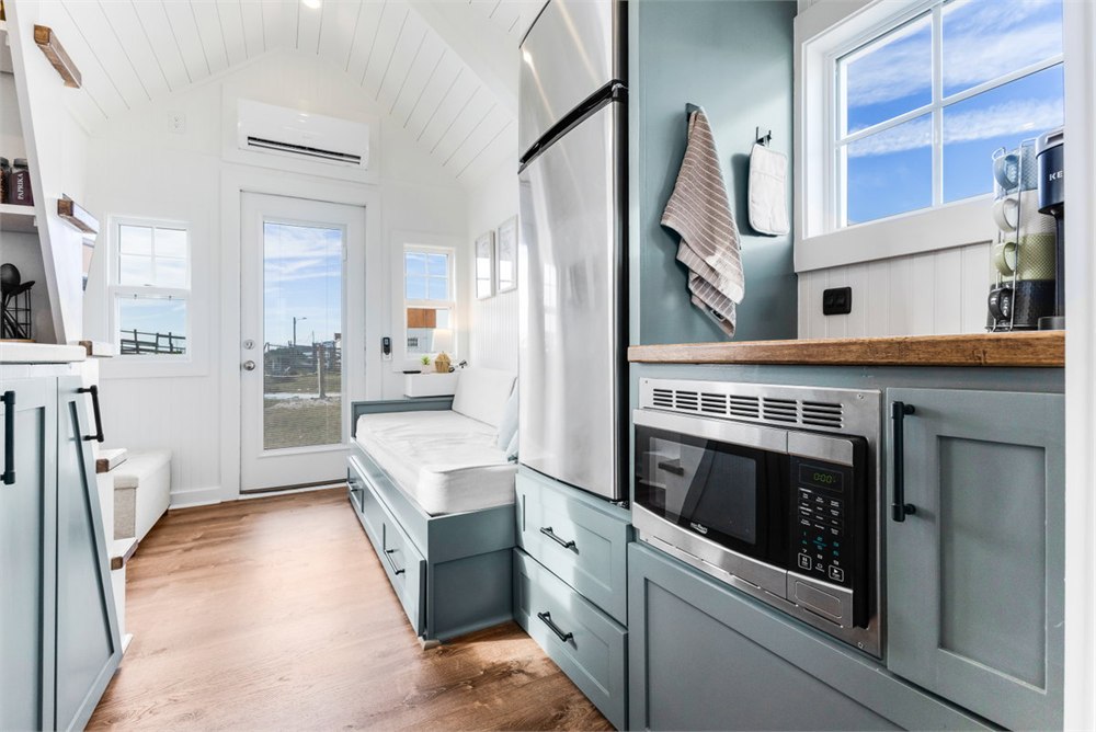 Petite Pelican tiny house galley kitchen with cabinetry on both sides