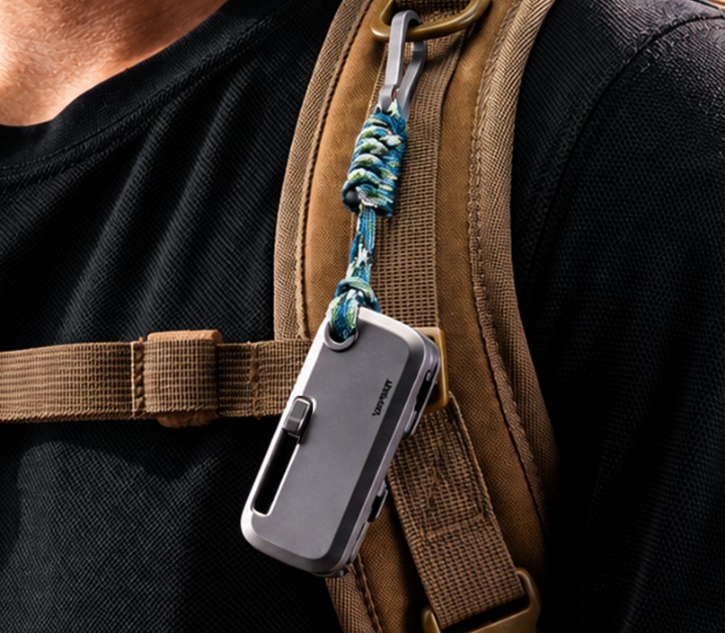 Compact TOOLT hanging from a backpack strap
