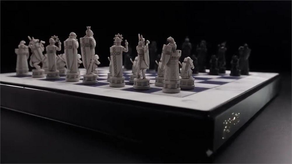 Sculpted pale and black pieces on the GoChess Wizard Alive chessboard