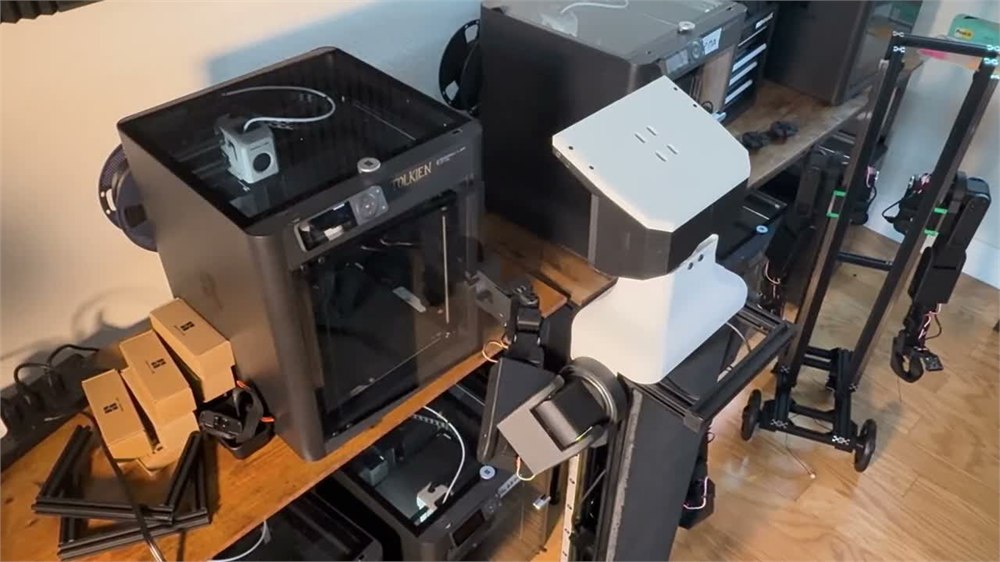 NORI robot working beside a 3D printer in the workshop