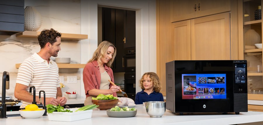 Manufacturer image of a family beside the countertop cooking robot