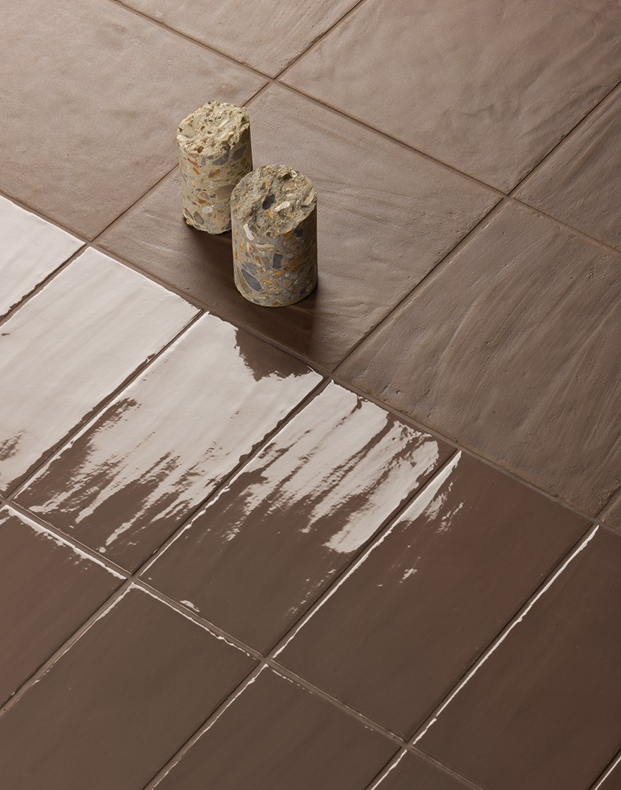 Glossy Mud tiles reflecting light across their textured surface