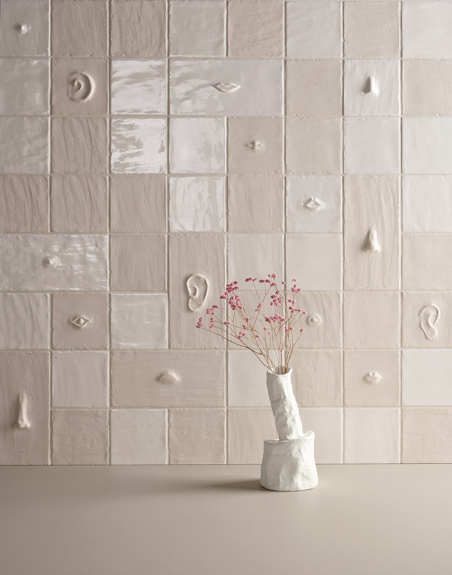 Chalk wall tiles with raised ears, eyes, noses and mouths