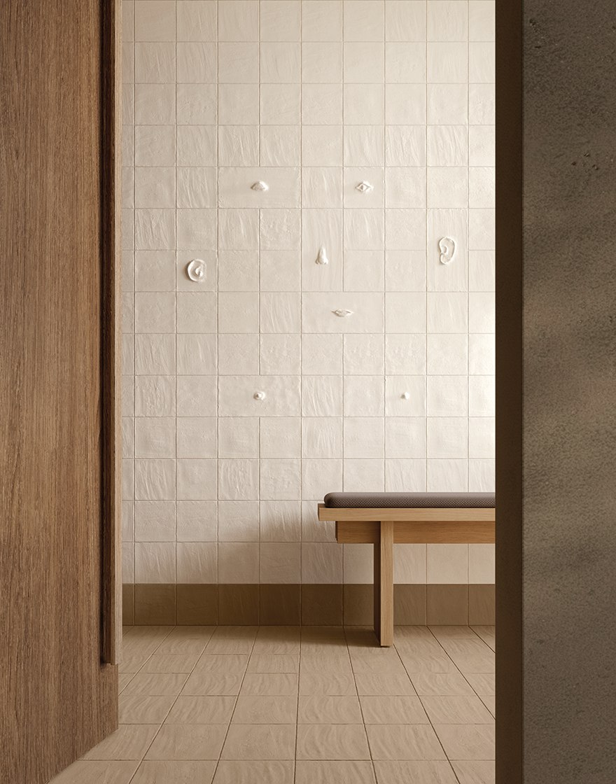 Entryway installation with scattered sculptural features in a Chalk tiled wall