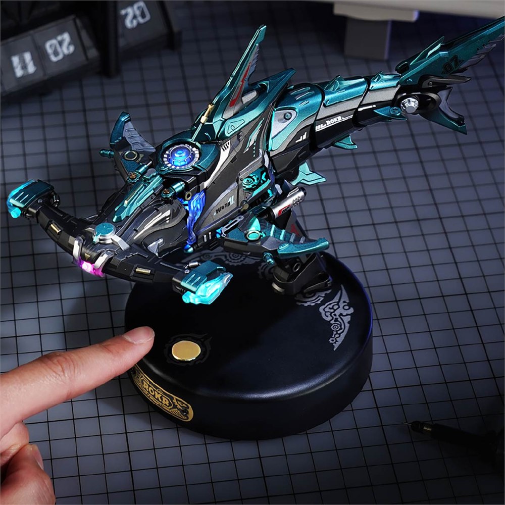 Finger activating the round display base beneath the mechanical shark