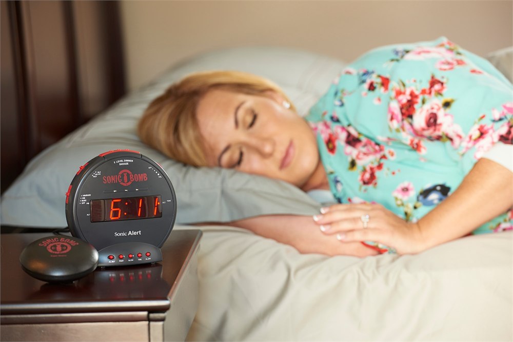 Sonic Bomb alarm clock and bed shaker on a bedside table