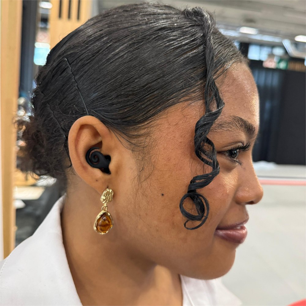 Black spiral earplug fitted into the outer ear
