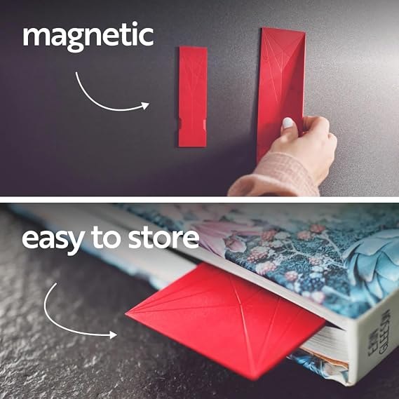 Red POLYGONS spoons stored flat on a magnetic surface and beside a book