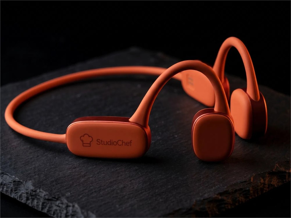 StudioChef KAI orange headset on a dark prep surface