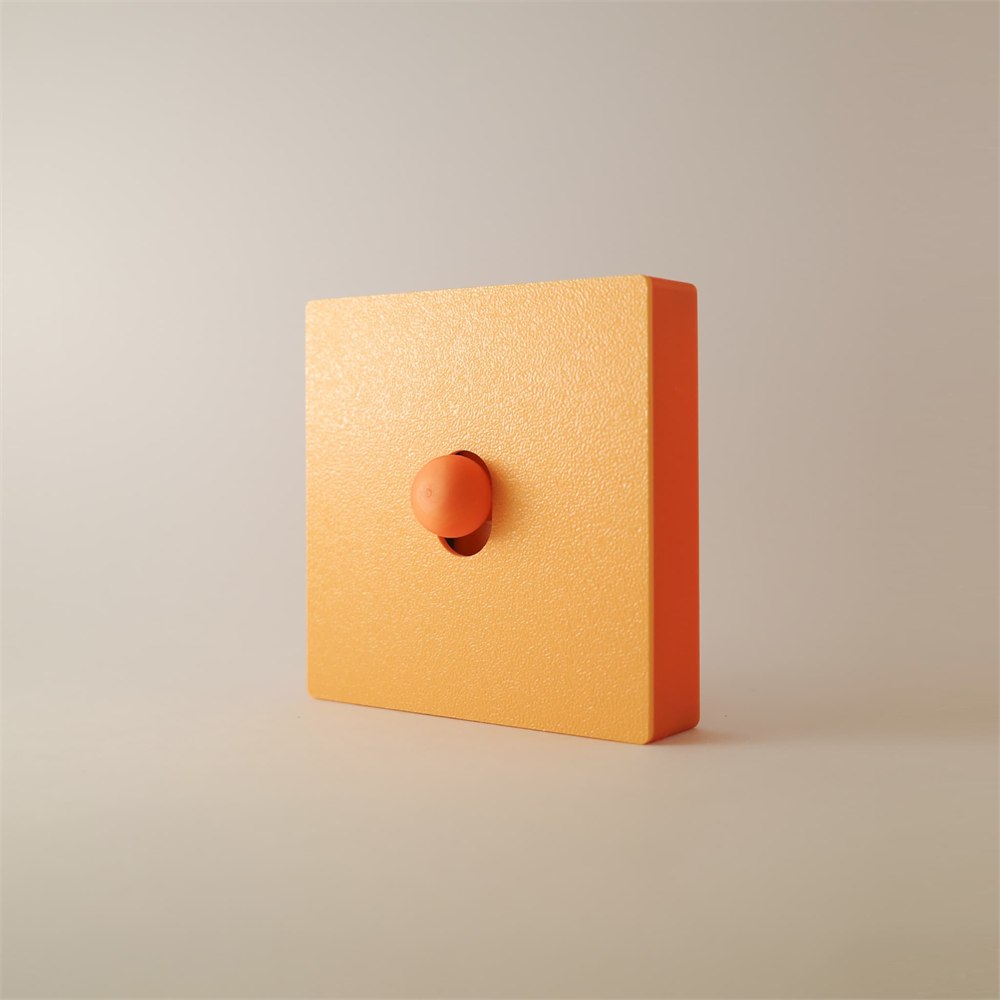 Apricot orange switch cover showing its left side and round button