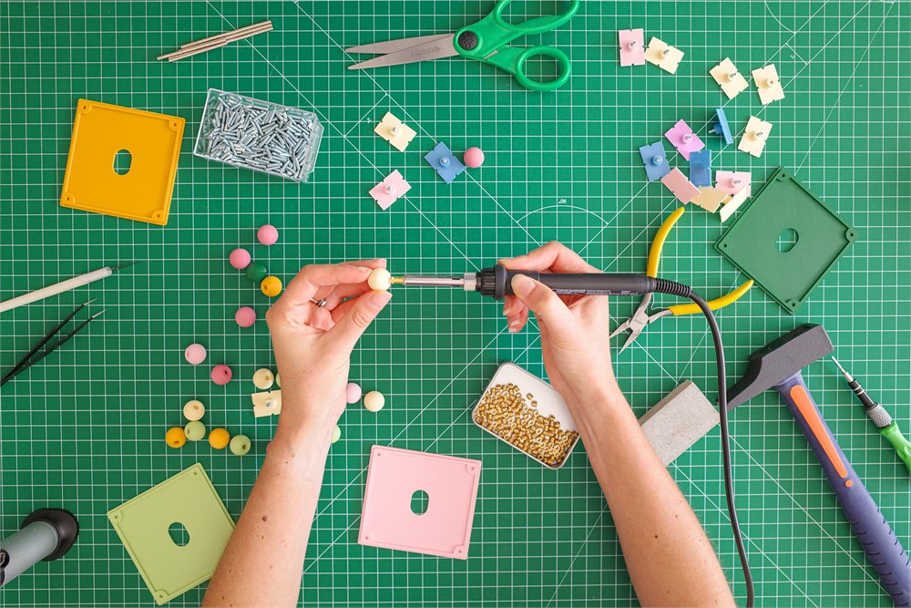 KOVR workshop assembling colorful cover buttons by hand