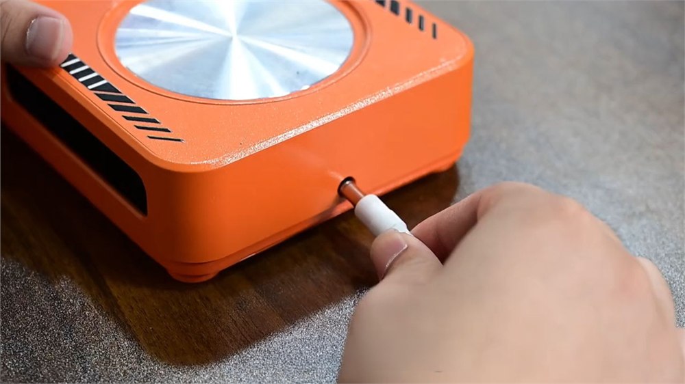 THERMA coaster power adapter plugged into an outlet