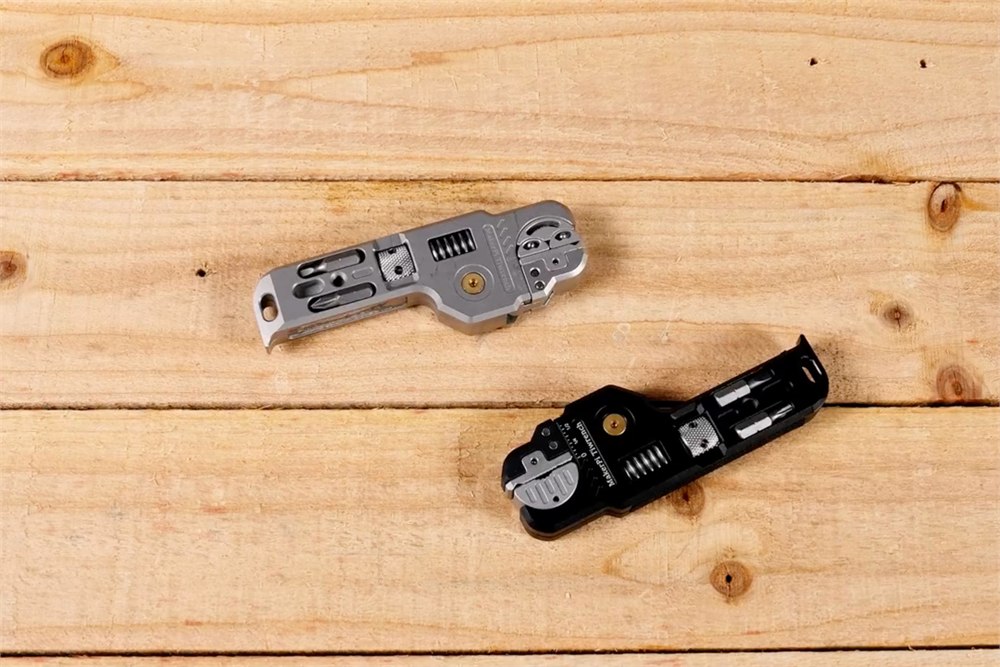 MakerPi Tiwrench aluminum and titanium versions on a wooden bench