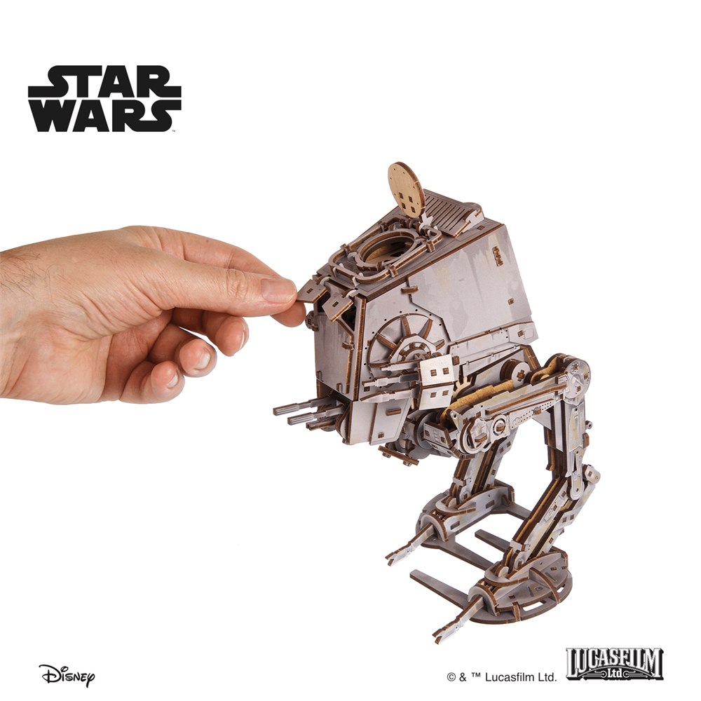 Hand opening the top hatch on the wooden AT-ST model