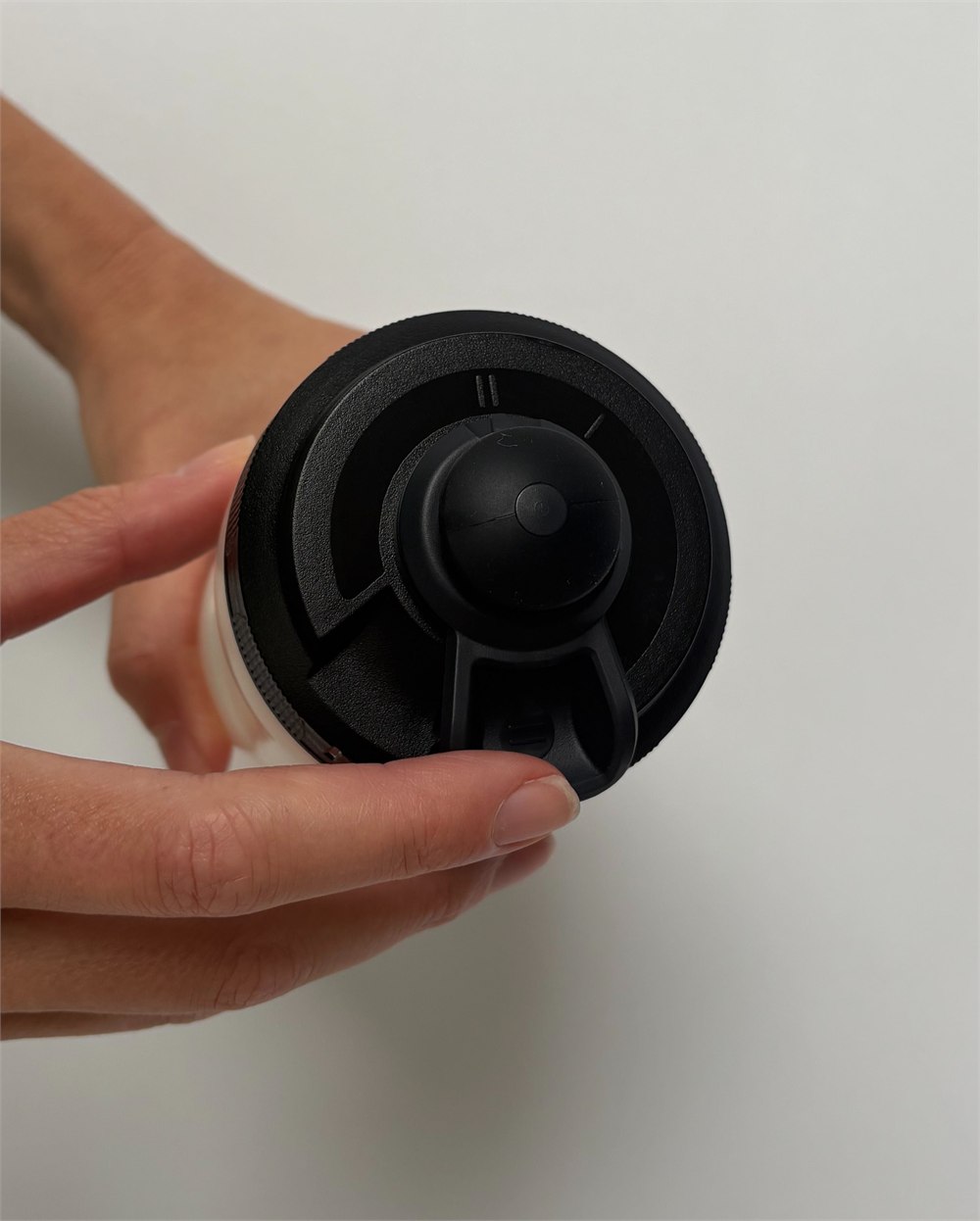 Hand operating the black lid selector