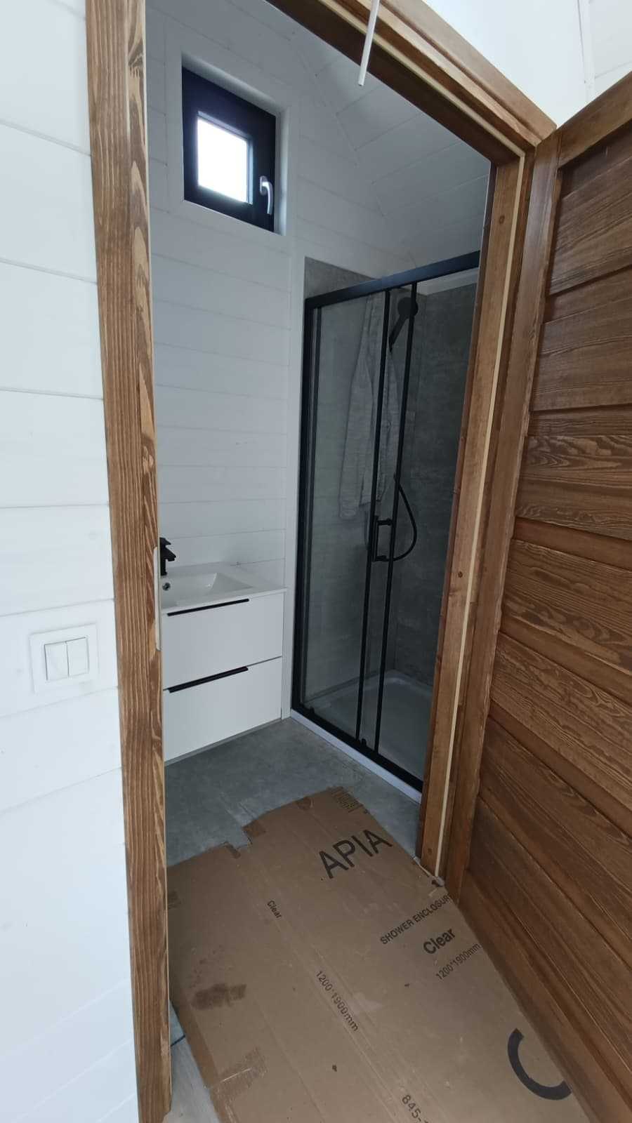 Glass shower enclosure beside the bathroom doorway