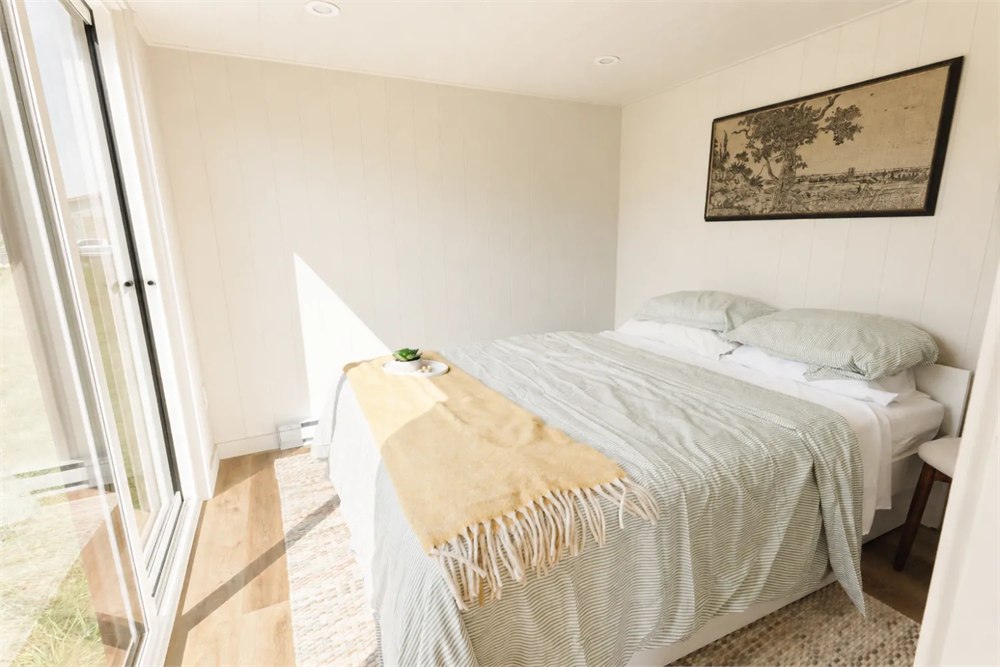 Ventura main-floor bedroom with a queen bed and glazed exterior doors