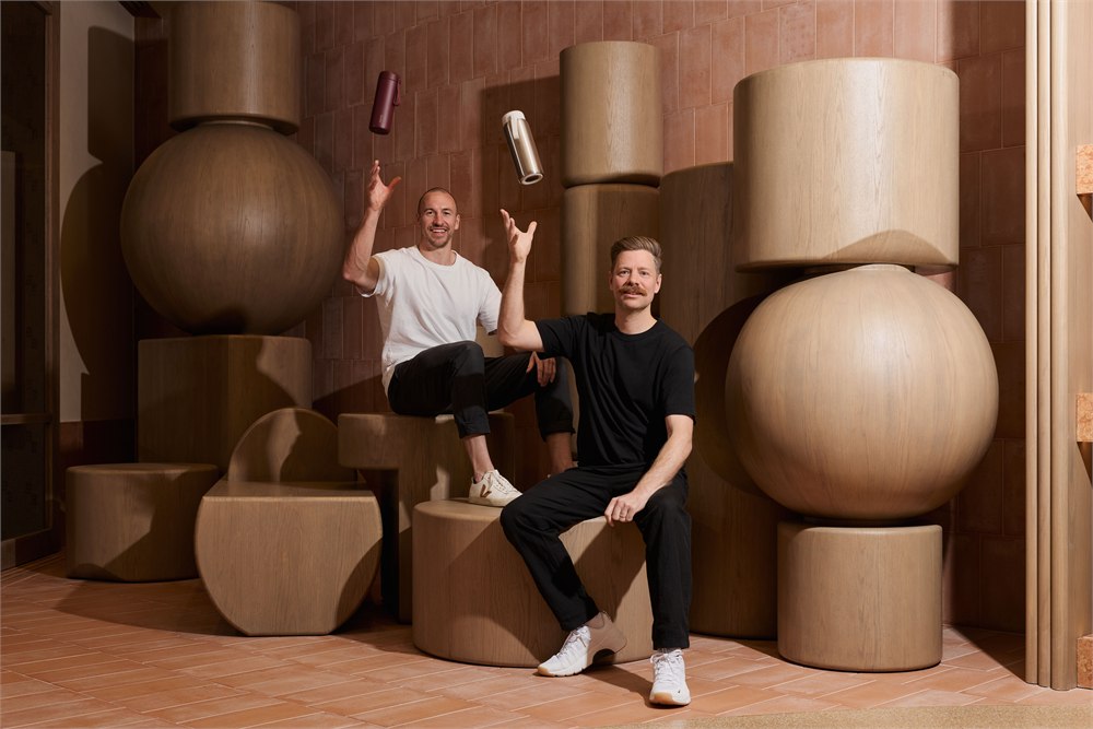 Memobottle founders posing with ROUND bottles in a studio