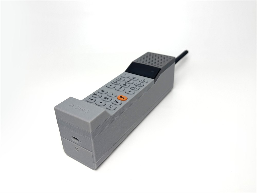 Handset resting on a white surface with its bottom port visible