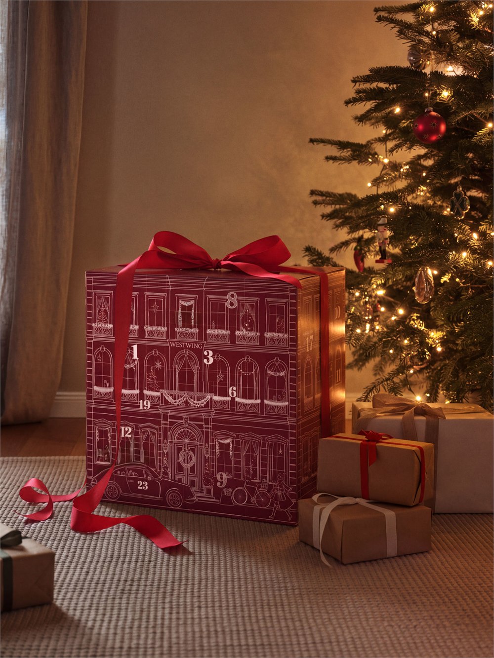 Oversized Advent calendar beside a Christmas tree