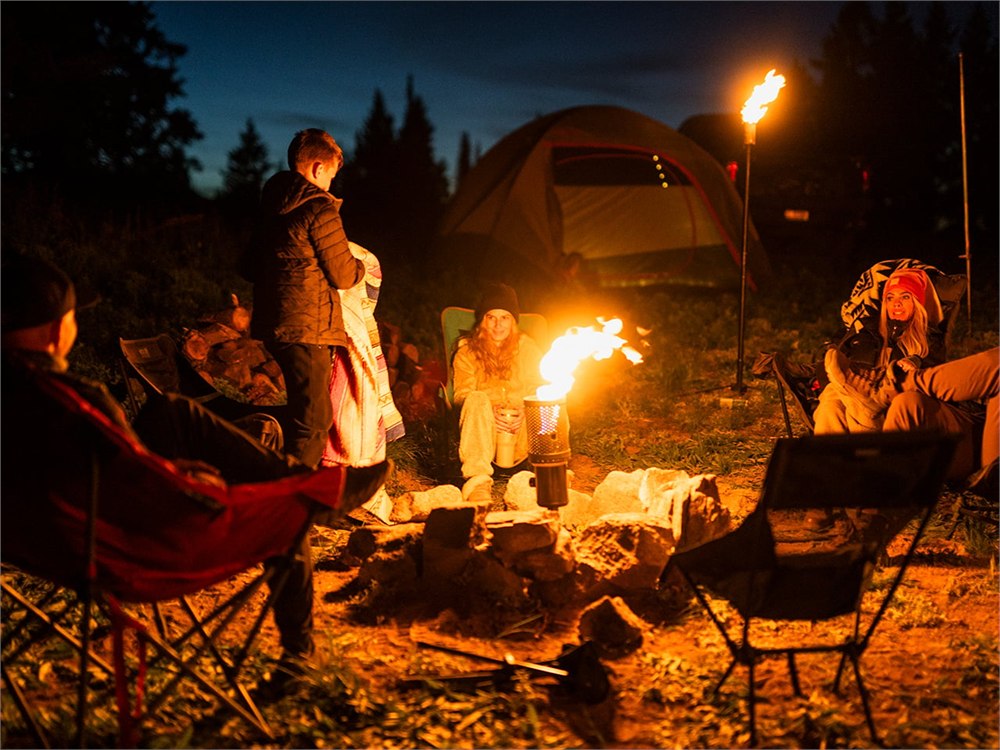 Camp Torch lighting a group of campers at night